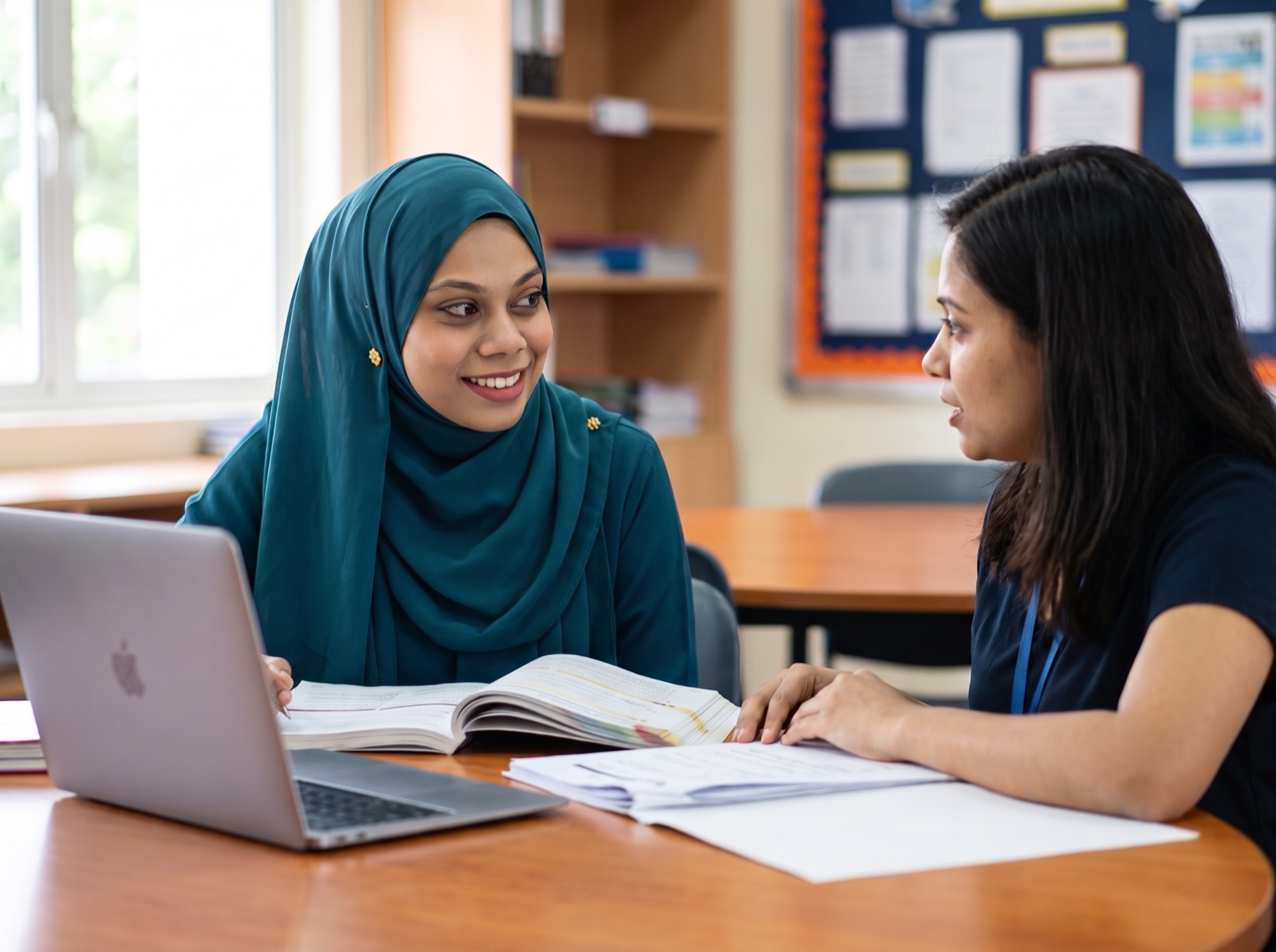 Ayesha in a planning conversation with a colleague